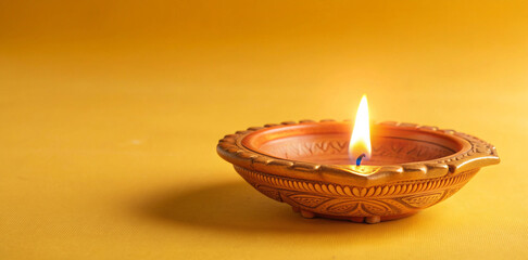 Divine Glow of Clay Diya on Beautifully Crafted Thali: A Testament to Hindu Faith and Tradition