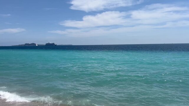 View of the Bay of Cannes with red rocks of Cap Esterel, Cannes, Cte d Azur, France. Cannes beach - France, Provence-Alpes-Cote d'Azur, View from beach to yachts in the evening. View of sea