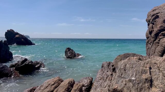 View of the Bay of Cannes with red rocks of Cap Esterel, Cannes, Cte d Azur, France. Cannes beach - France, Provence-Alpes-Cote d'Azur, View from beach to yachts in the evening. View of sea