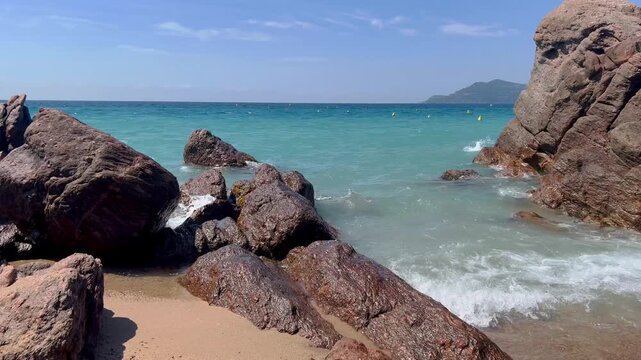 View of the Bay of Cannes with red rocks of Cap Esterel, Cannes, Cte d Azur, France. Cannes beach - France, Provence-Alpes-Cote d'Azur, View from beach to yachts in the evening. View of sea
