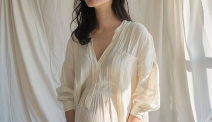 A woman is wearing a white dress and smiling