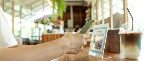 Woman use smartphone to scan QR code to pay in cafe restaurant with a digital payment without cash. Choose menu and order accumulate discount. E wallet, technology, pay online, credit card, bank app.