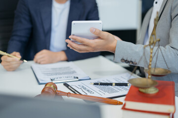 Business people and lawyers discussing contract papers sitting in the table at office, concepts of law, advice, legal services.