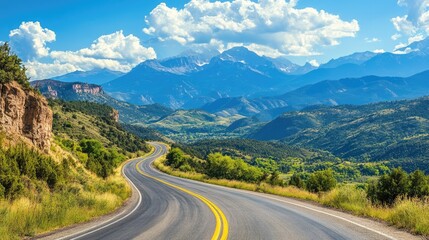 Fototapeta premium Scenic mountain road with sweeping turns and expansive views of distant peaks. Great for outdoor and travel imagery