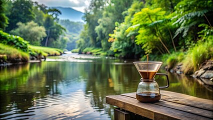 Fototapeta premium Coffee drip in nature park near river while camping, surrounded by lush greenery and tranquil water