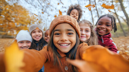 Happy diverse group of friends, cute young kids or teenage boys and girls with cheerful, joyful facial expressions taking a selfie or photo in an autumn forest or park, happiness and diversity