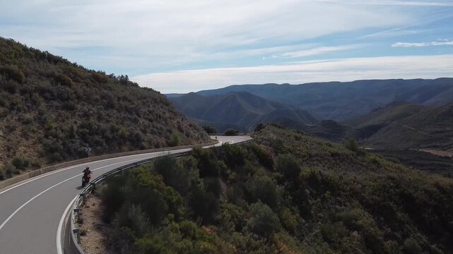 Drone view of a motorcycle in a mountain road