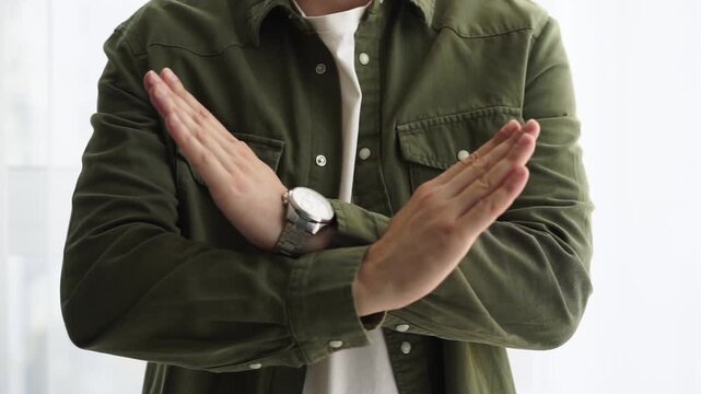 STOP hand gesture
The guy shows a denial gesture with his hands.
No, stop.