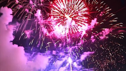 Close up spectacular view of vibrant colorful fireworks at night in the sky. Dynamic view of vivid fireworks exploding for celebration.
