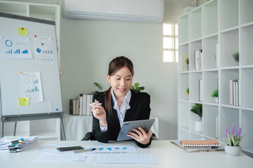 Professional Female Accountant Working in Modern Office Analyzing Financial Data on Tablet