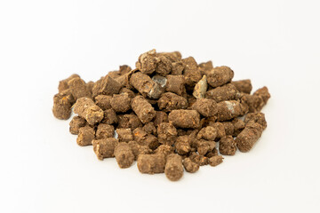 Pile of natural banana peel fertilizer - Eco-Friendly gardening solution isolated in white background. Pellet fertilizer from banana dried peels for planting.