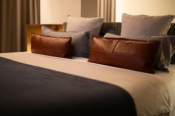 leather pillows cushions neat modern bed blue blanket topsheet sheets hotel room