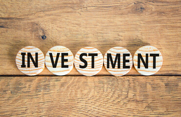 Naklejka premium Investment symbol. Concept word Investment on beautiful wooden circles. Beautiful wooden background. Business investment concept. Copy space.