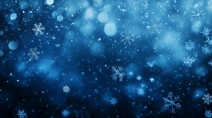 Fototapeta premium Snowflakes falling over dark blue background with bokeh effect