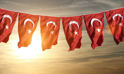 Turkish flags waving at sunset.