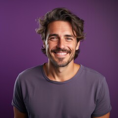 Fototapeta premium Smiling man against a purple background, perfect for promotional materials, website banners, or profile pictures highlighting positivity and friendly demeanor,