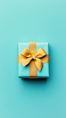 Elegant blue gift box with golden ribbon on turquoise background