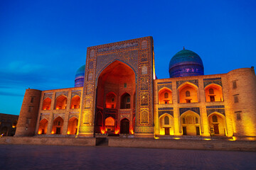 Ancient Mir-i-Arab madrasah in beautiful night illumination.
