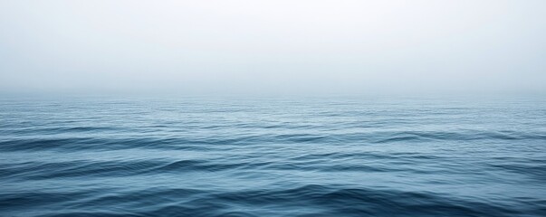 Fototapeta premium Fog blending with blue ocean on cloudy day