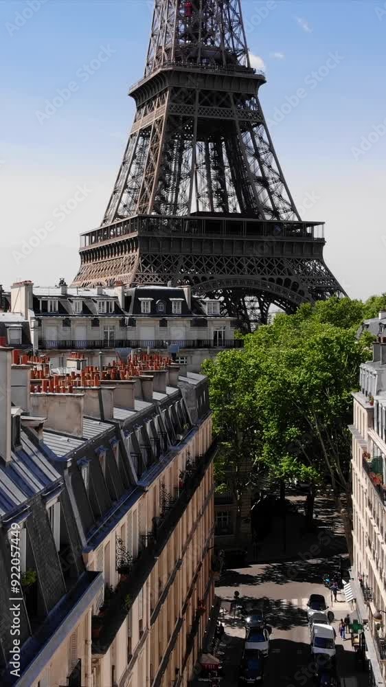 Wall mural eiffel tower in paris, france aerial view. vertical video format from a drone
