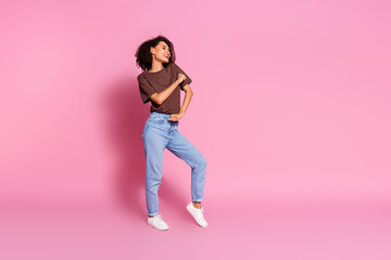 Photo of charming cheerful glad girl wear brown trendy clothes have fun dance look empty space offer isolated on pink color background