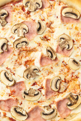 the macro composition of pizza for the menu. fresh ingredients are cheese, ham and tomatoes.