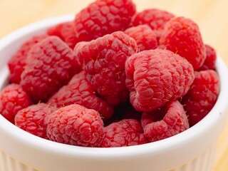 Close-up of fresh raspberries in a white bowl