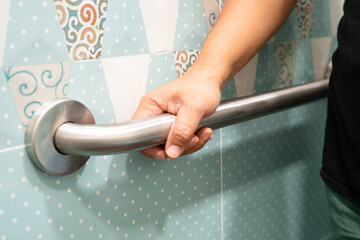 Asian elderly woman use toilet bathroom handle security, healthy strong medical concept.