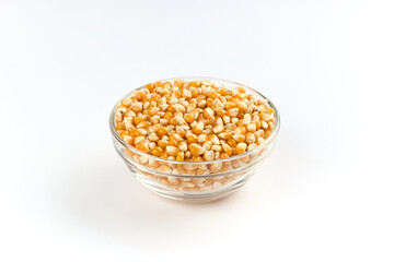 raw popcorn or corn in a bowl on white background