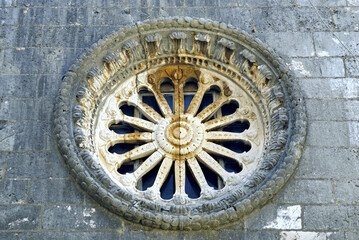 Fragment of the Church of St. Nicholas in Perast: rose window with Baroque decor. Decoration of the portal of the main Catholic church in the city of Perast (Bay of Kotor, Montenegro).