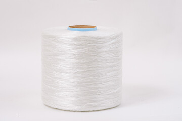  A close-up of a single large spool of white fiberglass yarn with a blue core, isolated against a plain white background.