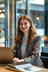 Obraz premium Young female business professional using a laptop