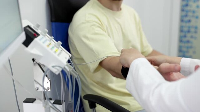 The patient undergoes an electromyography (EMG) test to assess nerve activity. Detects nerve and muscle dysfunctions. Perfect for showcasing advanced medical technologies
