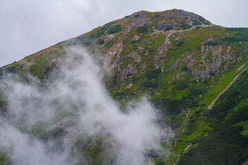 Beautiful mountain landscape with clouds and fog. 
