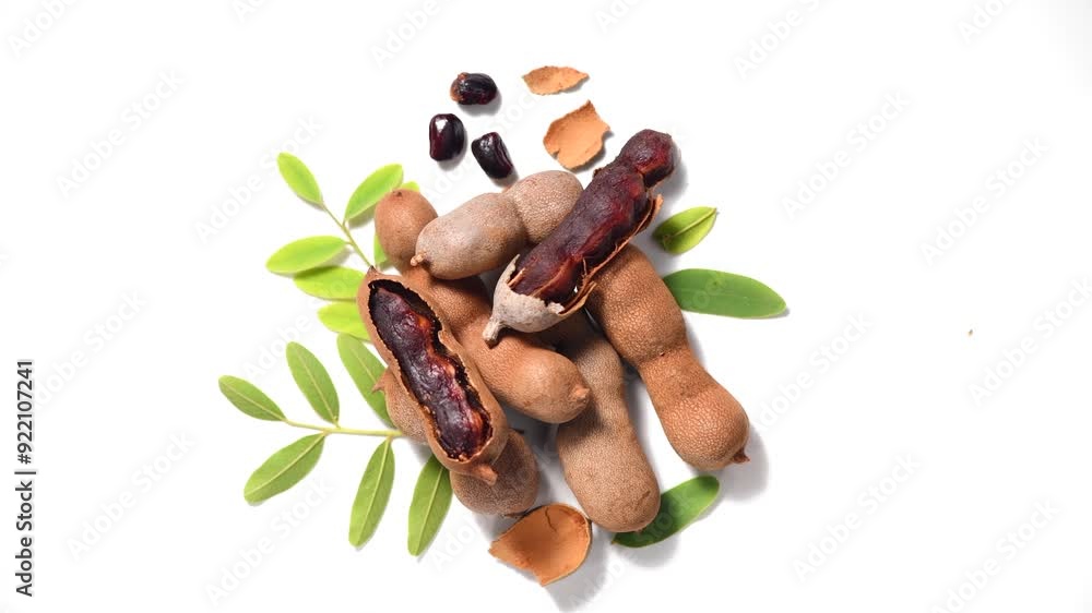 Canvas Prints Tamarind fruit isolated on white background. Tamarind tropical pods with leaves rotating. Fresh Tamarind pods with leaves (Tamarindus indica, Indian date), healthy vegan food close up, from above 