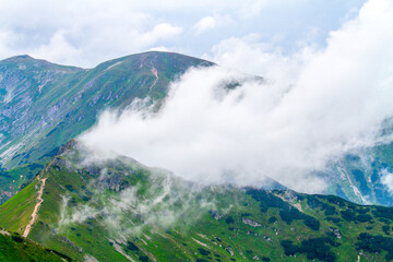 Beautiful mountain landscape with clouds and fog. 