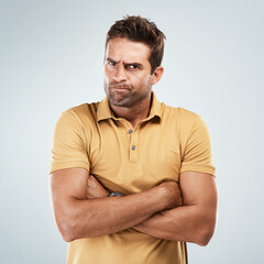 Man, angry and crossed arms in studio with white background for conflict, fight and attitude...