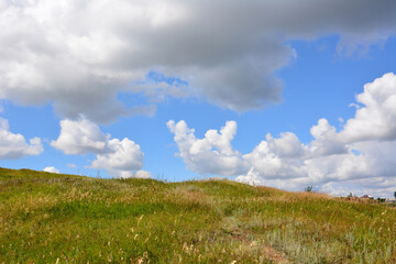 a hill with a sky that has clouds in it wallpaper  
