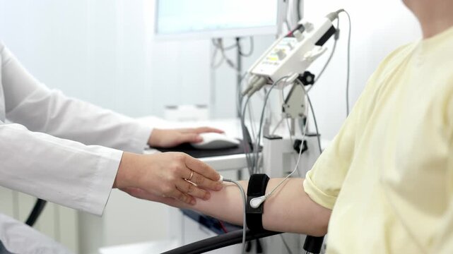 The patient undergoes an electromyography (EMG) test to assess nerve activity. Detects nerve and muscle dysfunctions. Perfect for showcasing advanced medical technologies