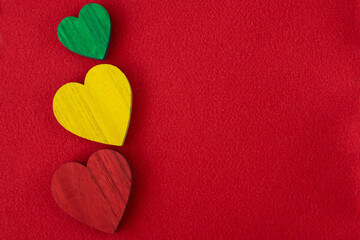 Obraz premium Traffic light green, yellow, red hearts on the red background.