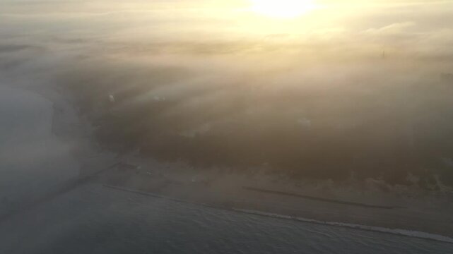 Sunrise Over the Palanga City Beach in Lithuania. Beautiful Cloudy Sky and Sun above it. Drone Shot