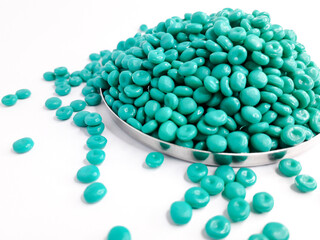 Aruba blue masterbatch granules on white background. Color pigment carrier polymer in plastic industry