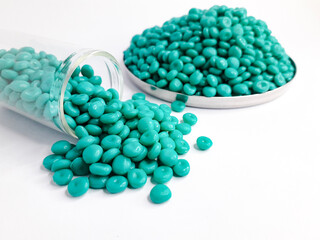 Aruba blue masterbatch granules on white background. Color pigment carrier polymer in plastic...