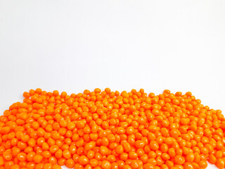 Sheer apricot masterbatch granules on white background. Color pigment carrier polymer in plastic industry