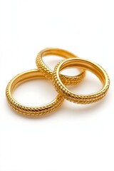 Three gold rings stacked on top of each other. The rings are all the same size and have a similar design