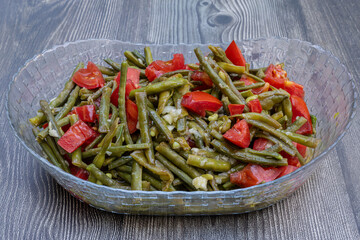 Fresh green beans salad. Turkish appetizer with tomato, lemon, olive oil and garlic sauce.