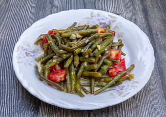 Fresh green beans salad. Turkish appetizer with tomato, lemon, olive oil and garlic sauce.