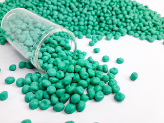 Sea green masterbatch granules on white background. Color pigment carrier polymer in plastic...