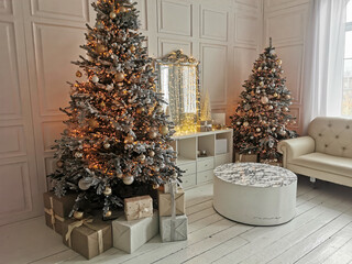 Beautiful holdiay decorated room with Christmas tree with presents under it