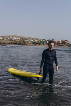  young guy surfers going for surfing in the ocean.